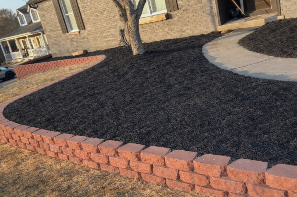 Cateye Services job site — custom retaining wall with fresh mulch in Northern Kentucky